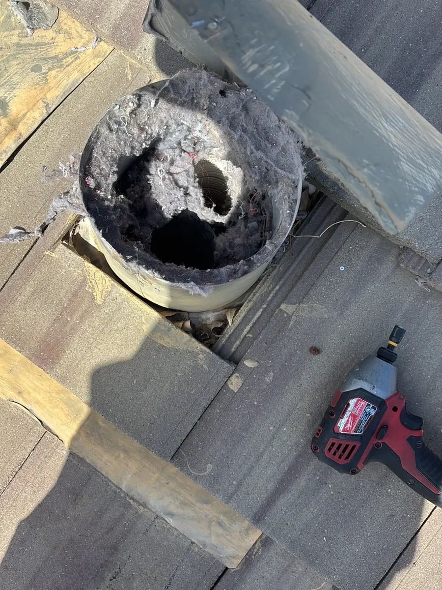 A roof dryer vent packed with lint